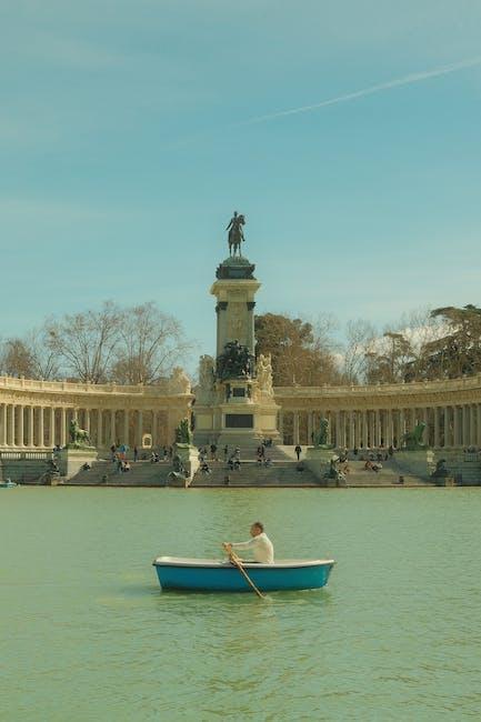 Man Rowing across Great Pond of el Retiro in Madrid, Spain