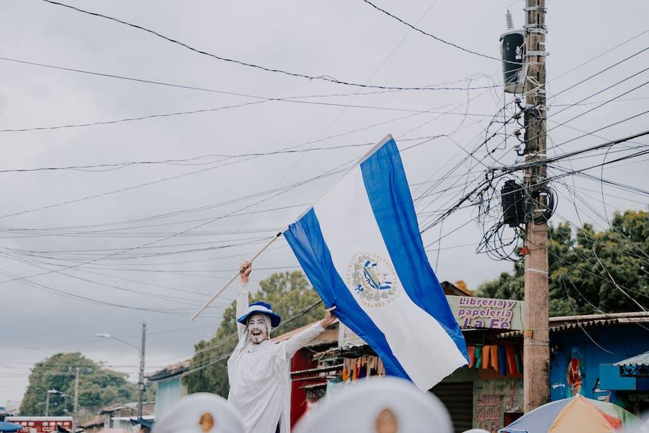 Man Waving an El Salvadoran Flag on the Street